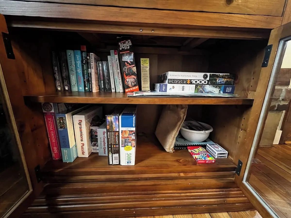 Cabinet shelves of books, puzzles and board games