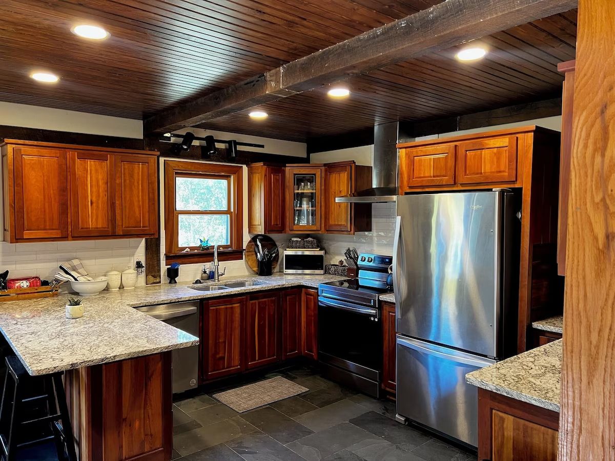 Kitchen with cherry cabinets, granite counters, and a slate floor